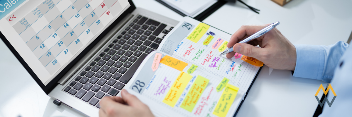 An organized desktop with laptop and notebooks